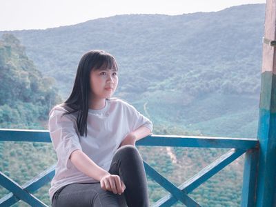 Woman sitting straight with perfect posture on a bench